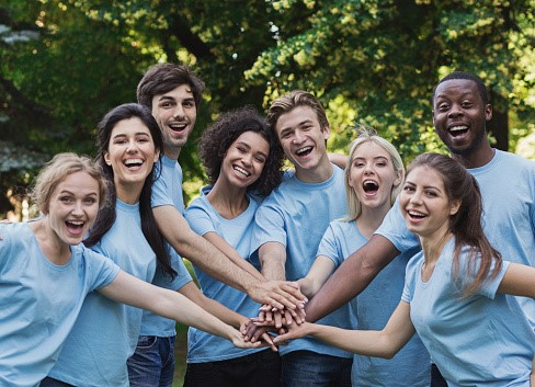 Photo of a mixed group of young happy volunteers