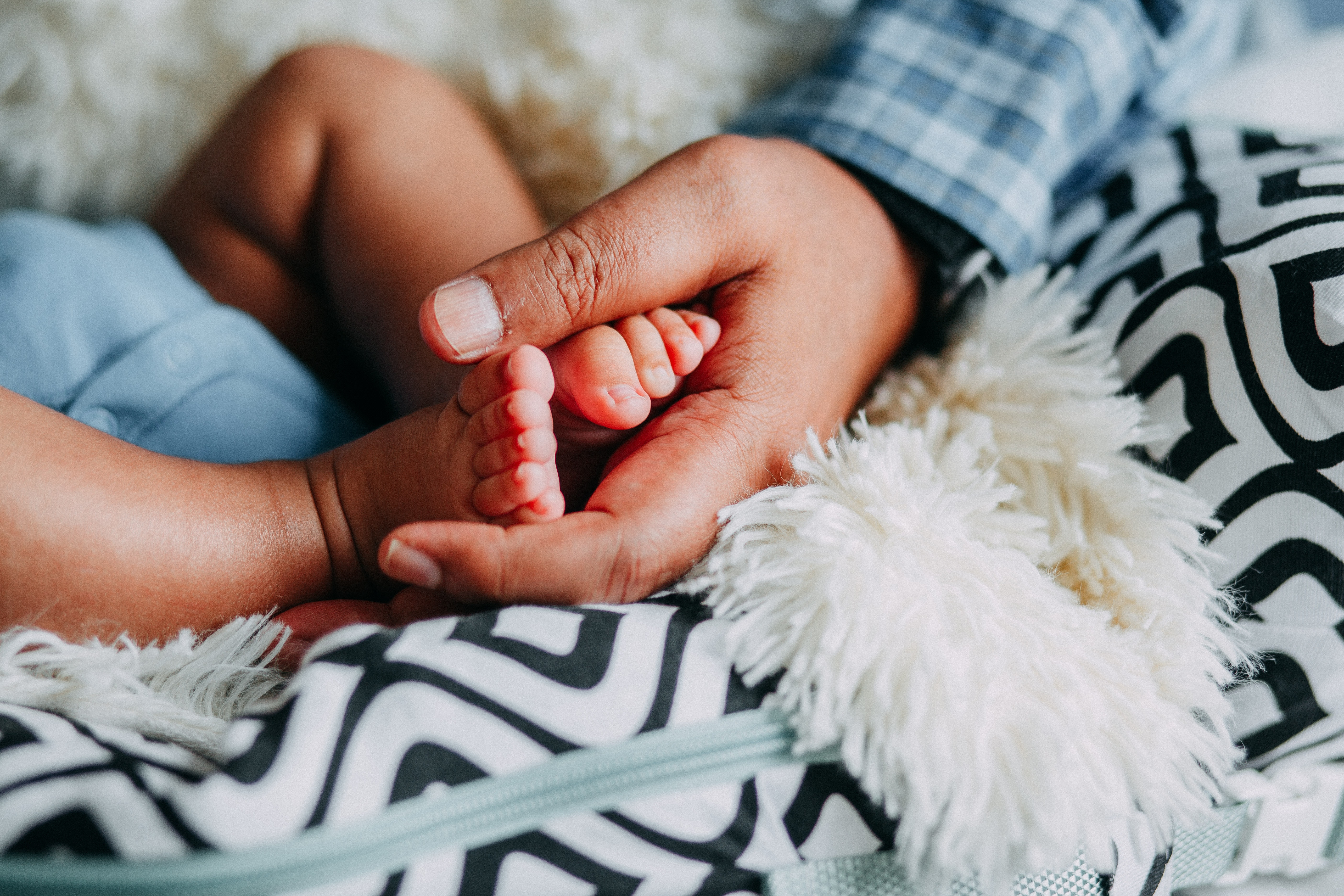 Baby's feet in parent's hands