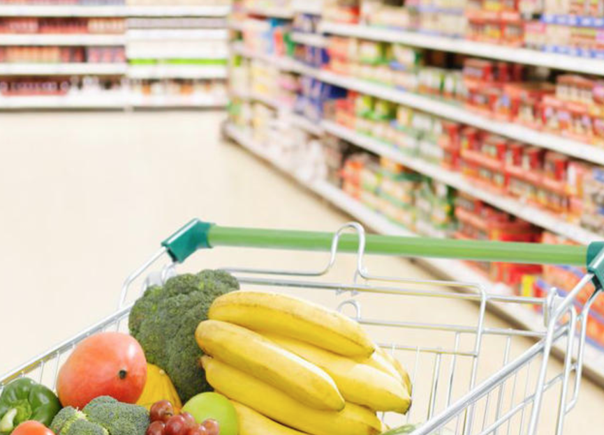 Supermarket trolley containing vegetables and fruit