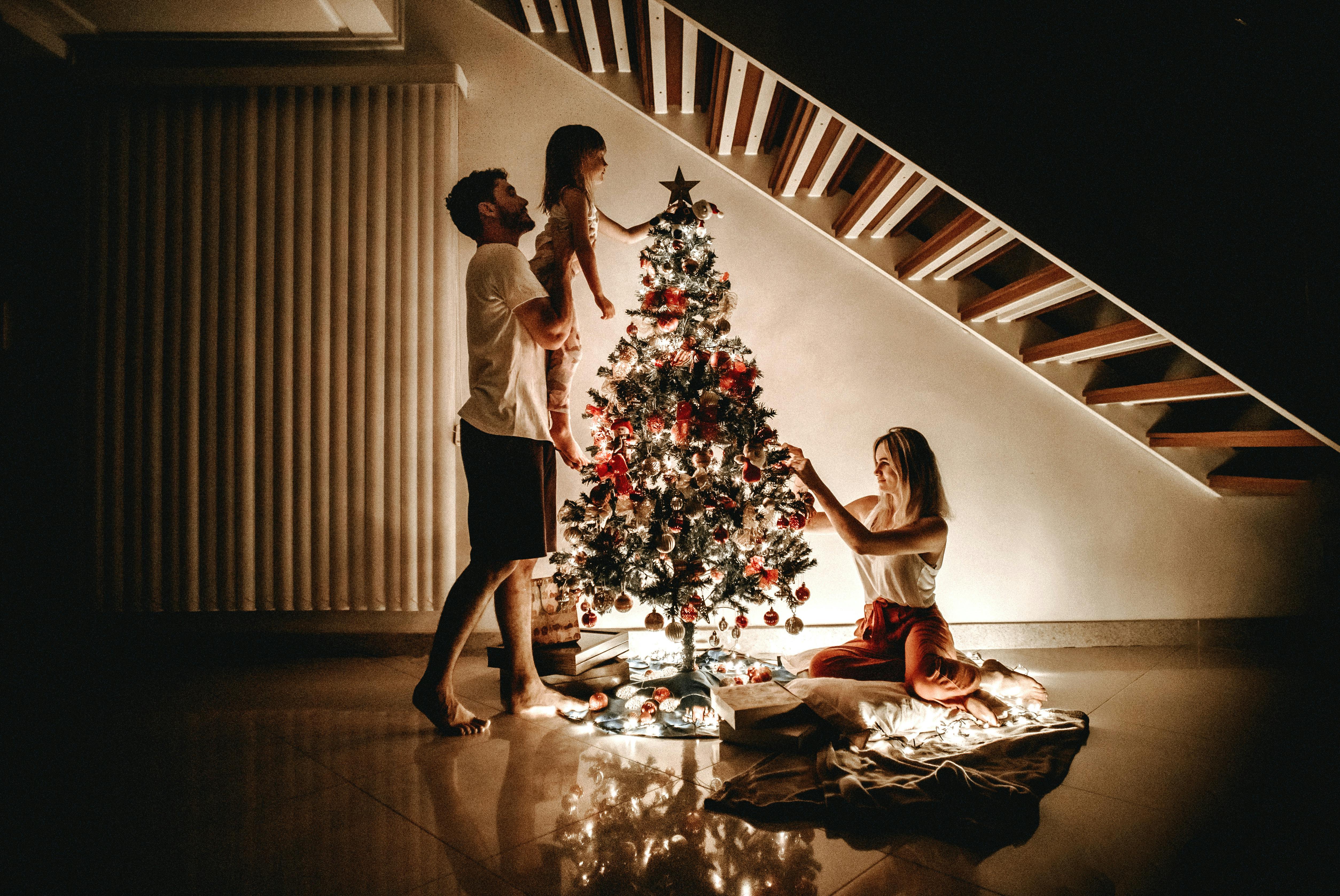 Stock image of a family decorating a tree