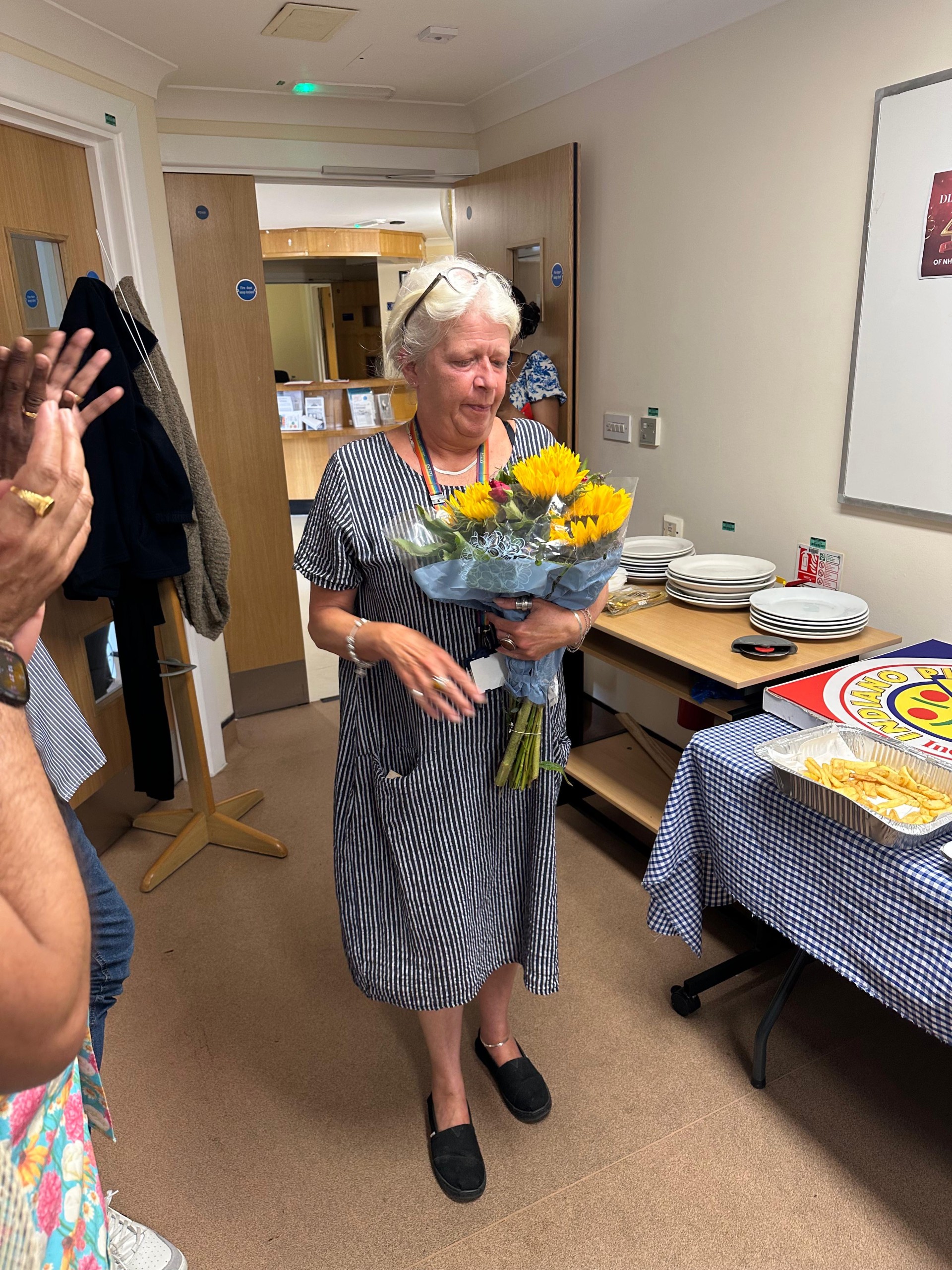 Diane Ball with sunflowers on 40 years in NHS celebration