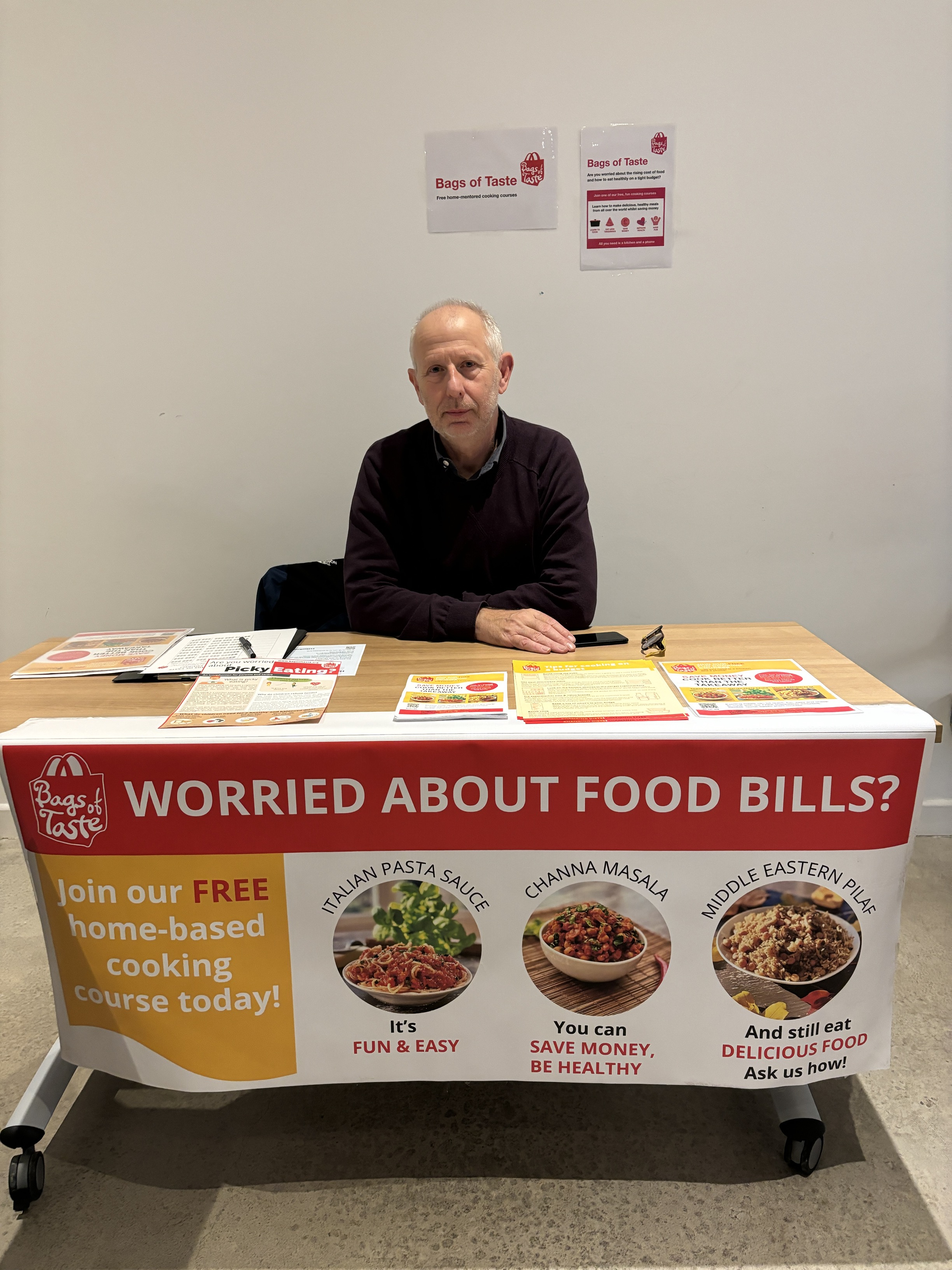 Bags of Life charity representative sitting behind a stall.