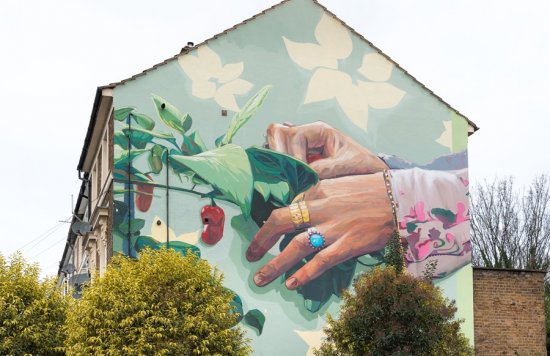 mural of hands touching plants