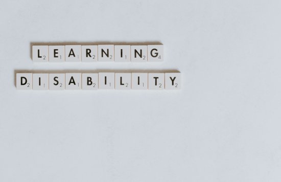 The words learning disability spelled out in Scrabble tiles
