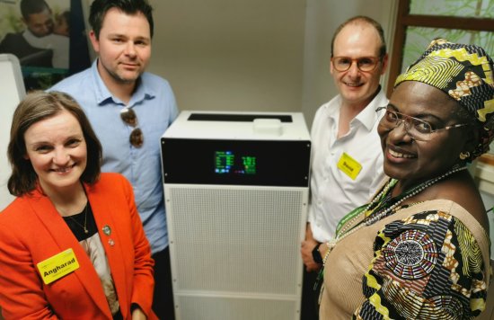 Members of the research team with one of the air cleaners
