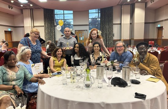 Attendees sitting at their table during the People Participation Awards.