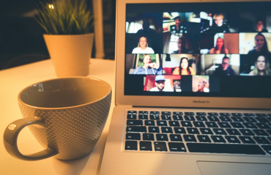 A Macbook displaying a video conferencing call.