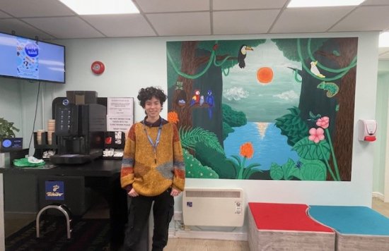 Az pictured in the reception next to the mural