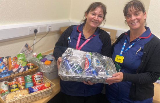 Two nurses from the Warfarin Service holding the hamper