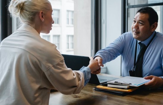 Stock image of two people shaking hands.