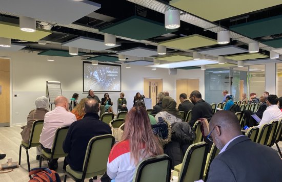 Attendees listening to a panel discussion from the NEL Mental Health Summit.