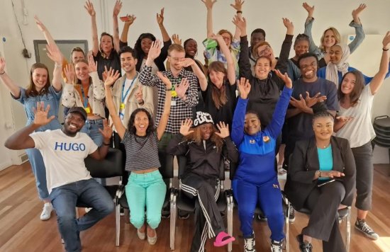 Colleagues from the Tree of Life project putting their hands in the air.