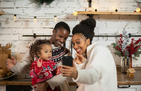 Stock image of a family with a young child over Christmas.
