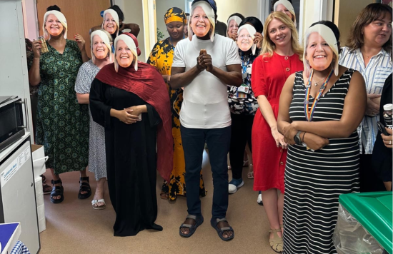 Diane's team pictured wearing masks of her face
