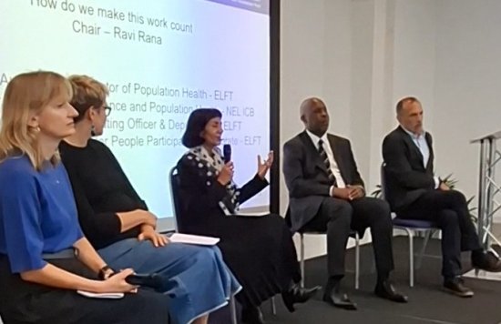 Panel members on stage at the conference