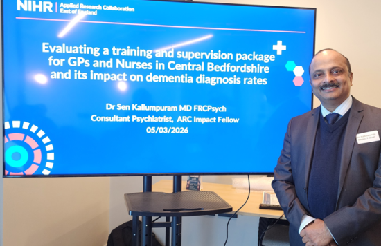 Dr Sen Kallumpuram in front of his presentation.