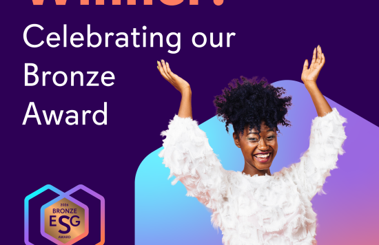 black female in white top and skirt with arms in the air in stance of celebration