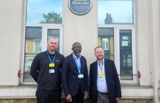ELFT colleagues standing in front of the plaque on Homerton High Street.