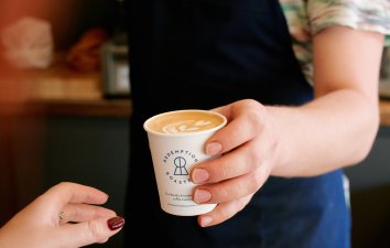 Handing over cup of coffee