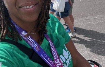 Black female in green running top smiling