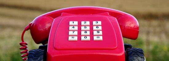 Red childs telephone on wheels with punch buttons